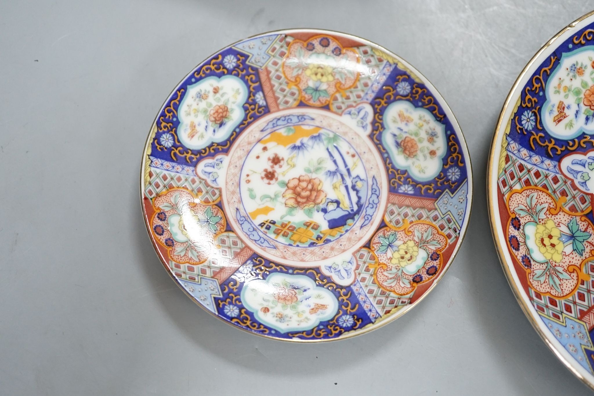 A Royal Crown Derby Imari bowl and two plates and another bowl, 25cm